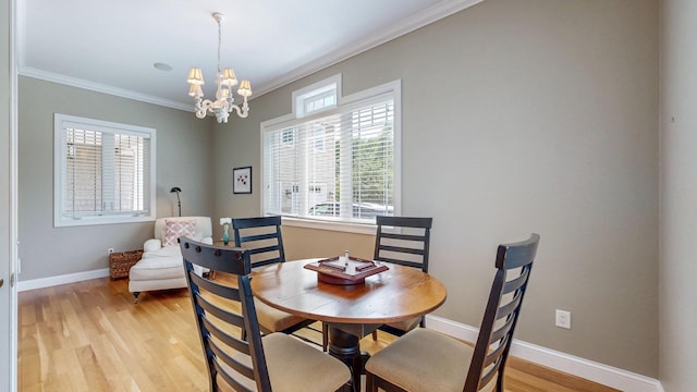 830 Prairie Island Rd N, Winona, MN 55987 - dining area with a chandelier, ornamental molding, and light wood-type flooring