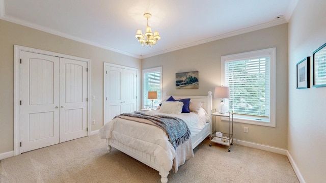 830 Prairie Island Rd N, Winona, MN 55987 - carpeted bedroom featuring two closets, a chandelier, and crown molding