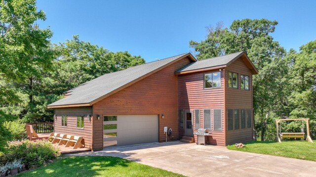 2756 7 5/8 Ave, Chetek, WI 54728 - view of front of home with concrete driveway, a garage, and a front lawn