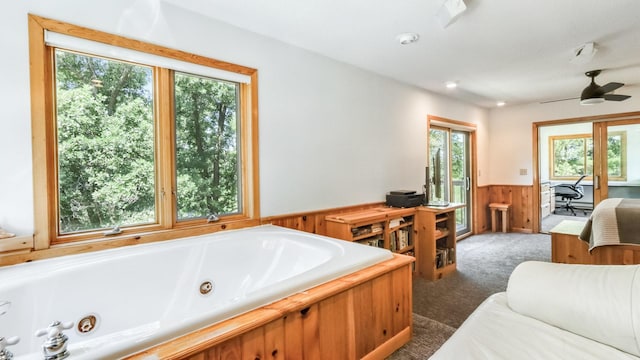 2756 7 5/8 Ave, Chetek, WI 54728 - bathroom with a wainscoted wall, a jetted tub, wood walls, and a ceiling fan