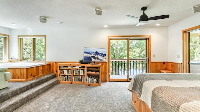 2756 7 5/8 Ave, Chetek, WI 54728 - bedroom with access to outside, a wainscoted wall, carpet, a textured ceiling, and wood walls