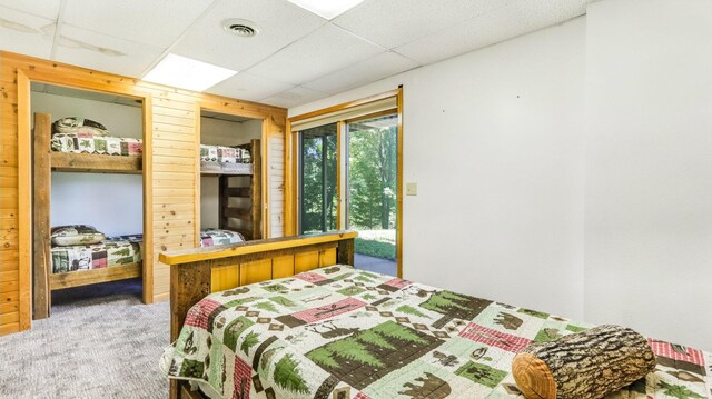 2756 7 5/8 Ave, Chetek, WI 54728 - carpeted bedroom with wooden walls and a paneled ceiling