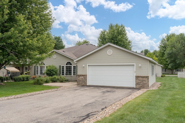 107 Oxford Path, Mankato, MN 56001 - view of front of home with brick siding, driveway, a garage, and a front lawn