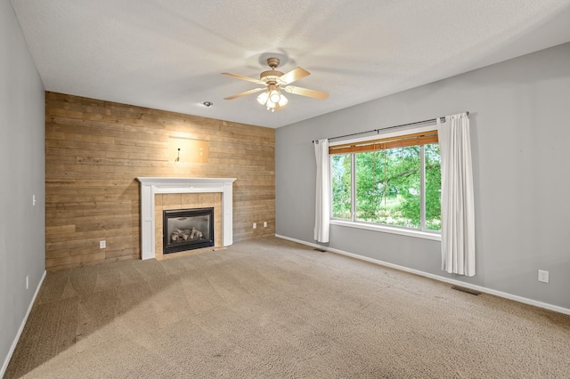 2403 Meadow Dr, Buffalo, MN 55313 - unfurnished living room with a ceiling fan, wood walls, a fireplace, and carpet flooring