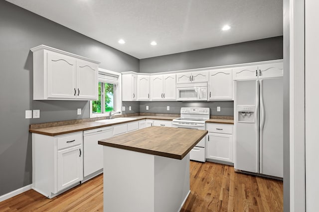 2403 Meadow Dr, Buffalo, MN 55313 - kitchen with white appliances, butcher block countertops, white cabinets, light wood-style floors, and recessed lighting