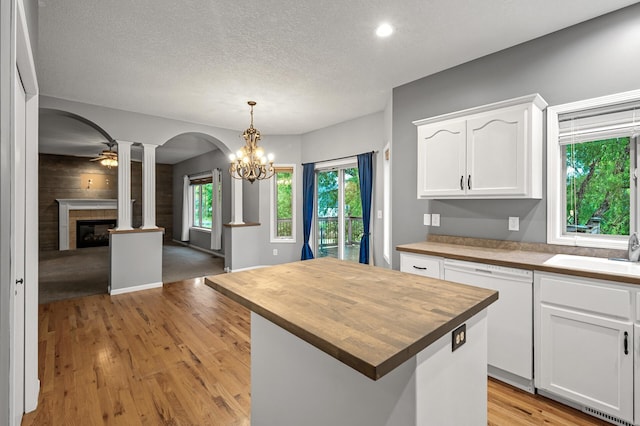 2403 Meadow Dr, Buffalo, MN 55313 - kitchen with white dishwasher, ornate columns, wood counters, arched walkways, and white cabinetry