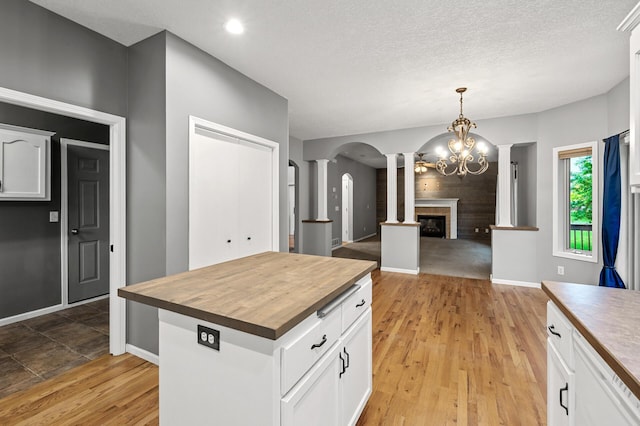 2403 Meadow Dr, Buffalo, MN 55313 - kitchen featuring decorative columns, butcher block countertops, white cabinets, and a textured ceiling