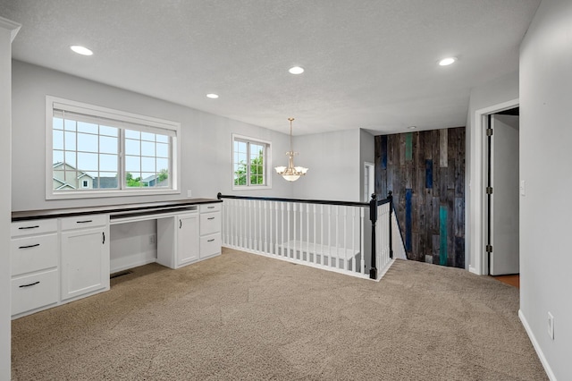 2403 Meadow Dr, Buffalo, MN 55313 - kitchen featuring dark countertops, light carpet, recessed lighting, white cabinets, and a chandelier