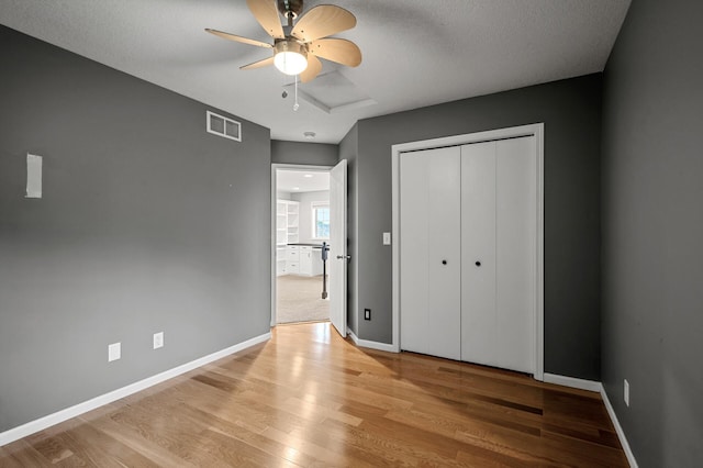 2403 Meadow Dr, Buffalo, MN 55313 - unfurnished bedroom with light wood-type flooring, a closet, and a ceiling fan