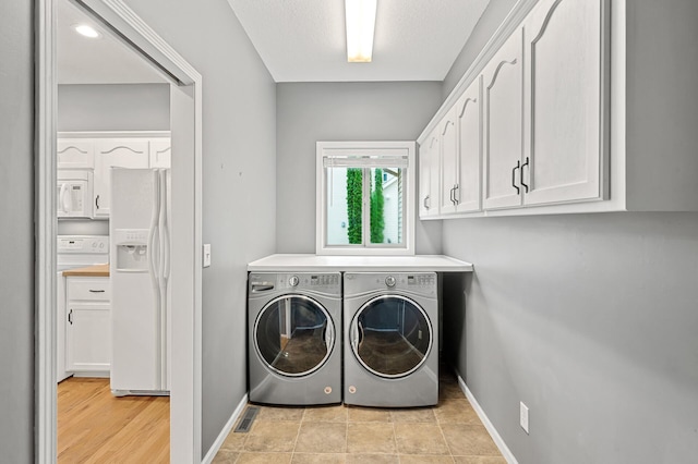 2403 Meadow Dr, Buffalo, MN 55313 - washroom featuring separate washer and dryer and cabinet space