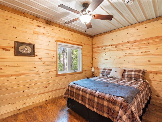 33638 Anderson Ct, Crosslake, MN 56442 - bedroom featuring wood walls, hardwood / wood-style floors, and ceiling fan
