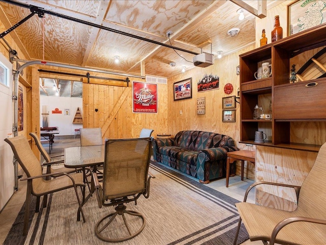 33638 Anderson Ct, Crosslake, MN 56442 - dining area with wood walls and a barn door