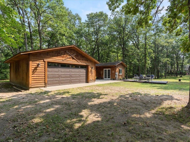 33638 Anderson Ct, Crosslake, MN 56442 - view of front of house with french doors, a garage, and an outbuilding