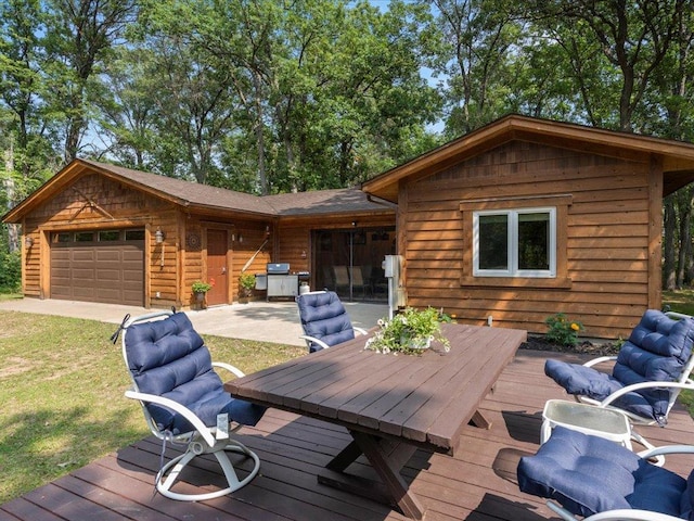 33638 Anderson Ct, Crosslake, MN 56442 - wooden terrace with a grill, a yard, an attached garage, and outdoor dining area