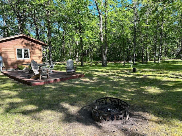 33638 Anderson Ct, Crosslake, MN 56442 - view of green lawn featuring an outdoor fire pit and a deck