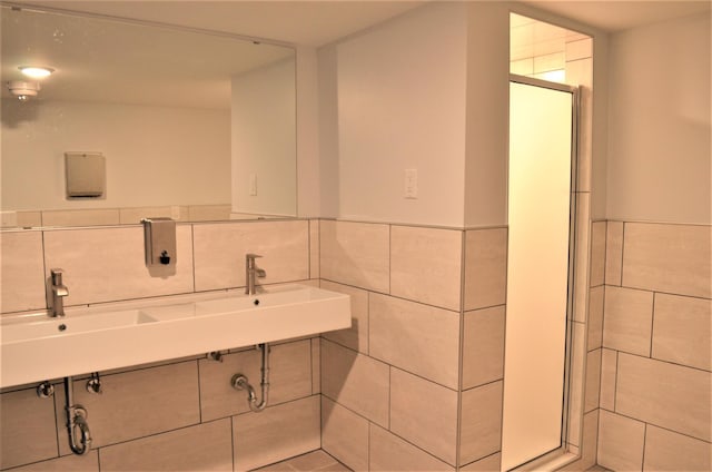 4387 Wilshire Blvd Unit 307, Mound, MN 55364 - bathroom with tile walls, a shower stall, a wainscoted wall, and pet washing area
