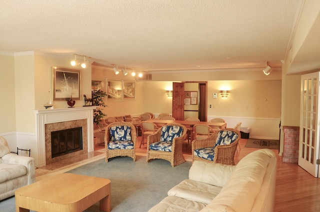 4387 Wilshire Blvd Unit 307, Mound, MN 55364 - living room with crown molding, a textured ceiling, rail lighting, and a high end fireplace