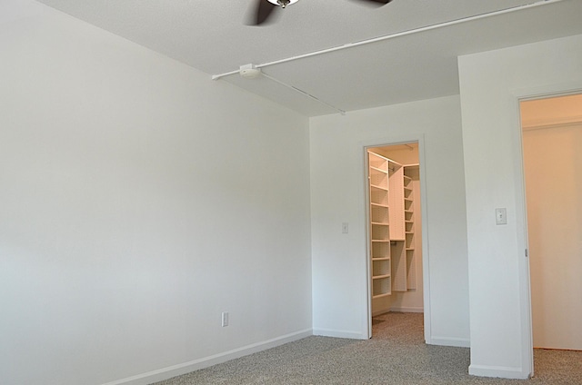 4387 Wilshire Blvd Unit 307, Mound, MN 55364 - unfurnished bedroom with a spacious closet, light carpet, and a ceiling fan