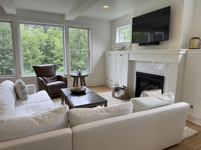 14169 Shady Beach Dr NE, Prior Lake, MN 55372 - living area with light wood finished floors, beamed ceiling, and a fireplace