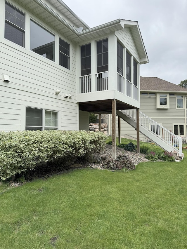 14169 Shady Beach Dr NE, Prior Lake, MN 55372 - view of side of property featuring a sunroom, a lawn, and stairs