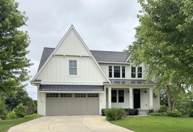 14169 Shady Beach Dr NE, Prior Lake, MN 55372 - view of front of house with board and batten siding, a standing seam roof, roof with shingles, and concrete driveway