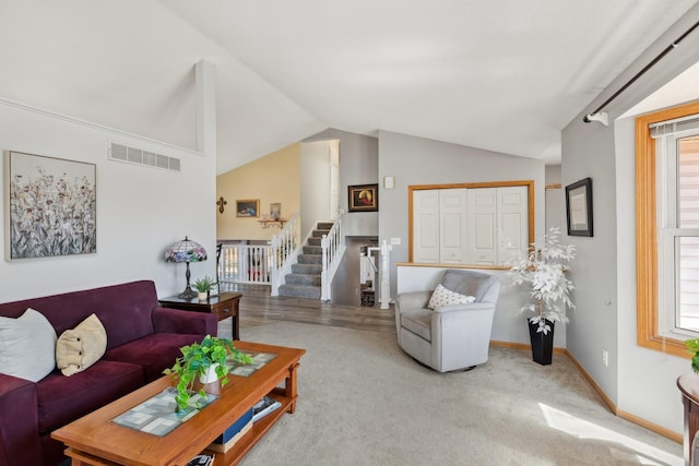 7175 Upper 157th St W, Apple Valley, MN 55124 - carpeted living area with lofted ceiling, stairway, and plenty of natural light