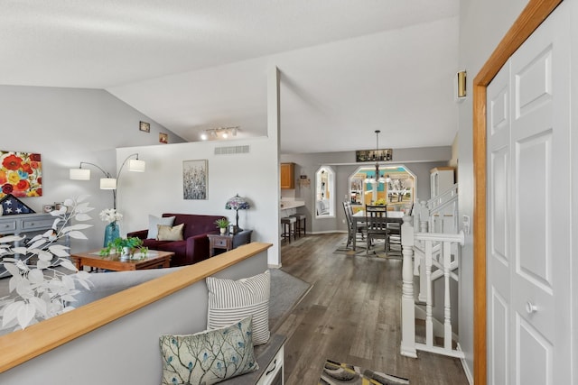 7175 Upper 157th St W, Apple Valley, MN 55124 - living room with dark wood-type flooring, vaulted ceiling, a chandelier, and arched walkways