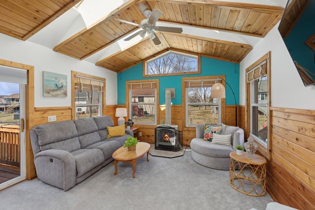 7175 Upper 157th St W, Apple Valley, MN 55124 - carpeted living room featuring wainscoting, a wood stove, wood ceiling, wood walls, and ceiling fan