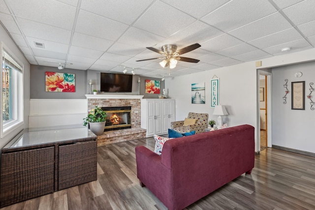 7175 Upper 157th St W, Apple Valley, MN 55124 - living area with a paneled ceiling, wood finished floors, a brick fireplace, and ceiling fan
