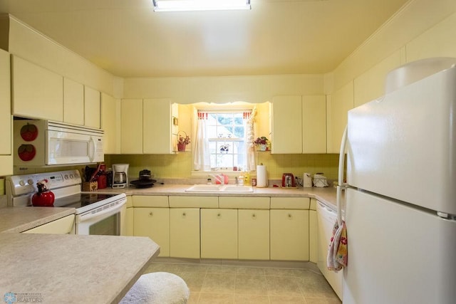 1245 1st St N, Fargo, ND 58102 - kitchen with white appliances, light countertops, tasteful backsplash, and cream cabinets