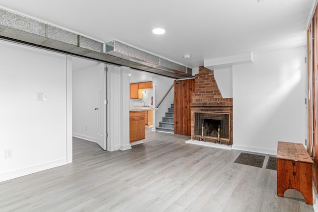 2196 7th St W, Saint Paul, MN 55116 - unfurnished living room with light wood-style floors, stairs, and a fireplace
