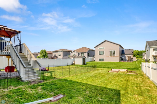 1334 6th St NW, Fargo, ND 58078 - fenced backyard featuring a residential view, stairway, a deck, and a shed
