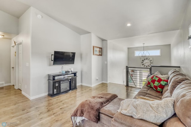 1334 6th St NW, Fargo, ND 58078 - living area with light wood-style flooring, a chandelier, recessed lighting, and vaulted ceiling