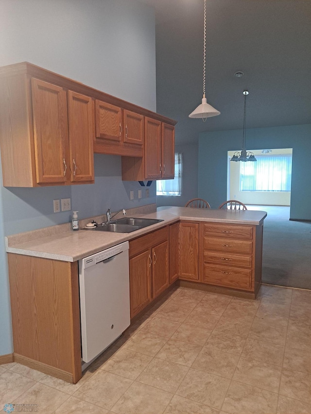5409 University Dr S Unit D, Fargo, ND 58104 - kitchen featuring dishwasher, light countertops, a peninsula, decorative light fixtures, and brown cabinetry