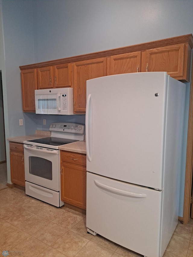 5409 University Dr S Unit D, Fargo, ND 58104 - kitchen with white appliances, brown cabinets, and light countertops