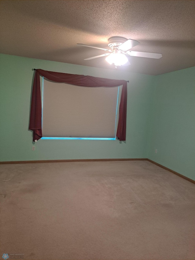 5409 University Dr S Unit D, Fargo, ND 58104 - carpeted spare room featuring a textured ceiling and ceiling fan