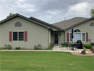 1308 25th Ave NW Unit Un110, Faribault, MN 55021 - back of property with a yard and a patio
