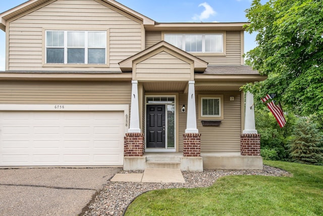 6758 Troy Ln N, Maple Grove, MN 55311 - view of front of house featuring brick siding, a garage, driveway, and a front lawn