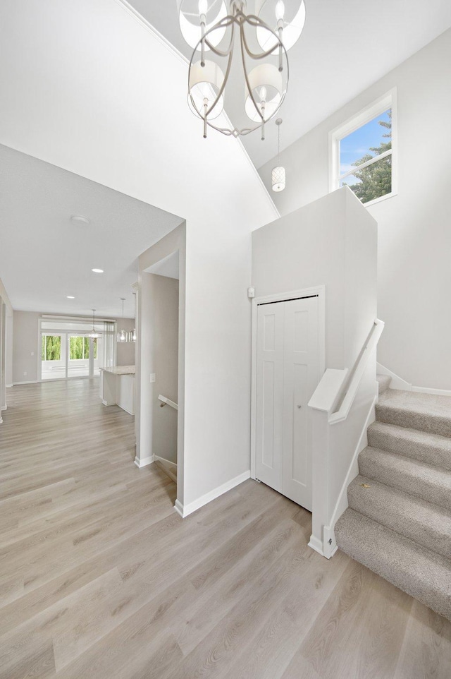 6758 Troy Ln N, Maple Grove, MN 55311 - stairs featuring a chandelier and wood finished floors