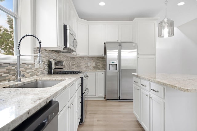 6758 Troy Ln N, Maple Grove, MN 55311 - kitchen with stainless steel appliances, recessed lighting, backsplash, white cabinets, and light wood-type flooring
