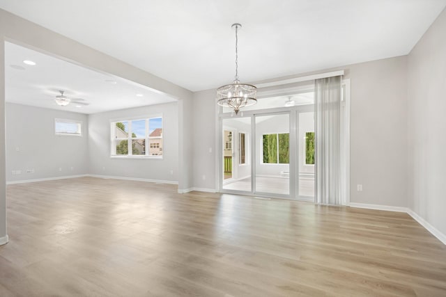 6758 Troy Ln N, Maple Grove, MN 55311 - empty room featuring a chandelier, light wood-style flooring, ceiling fan, and recessed lighting