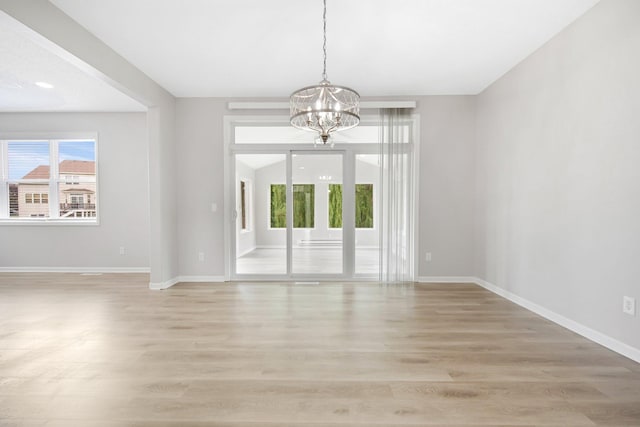 6758 Troy Ln N, Maple Grove, MN 55311 - empty room with a chandelier and light wood-type flooring