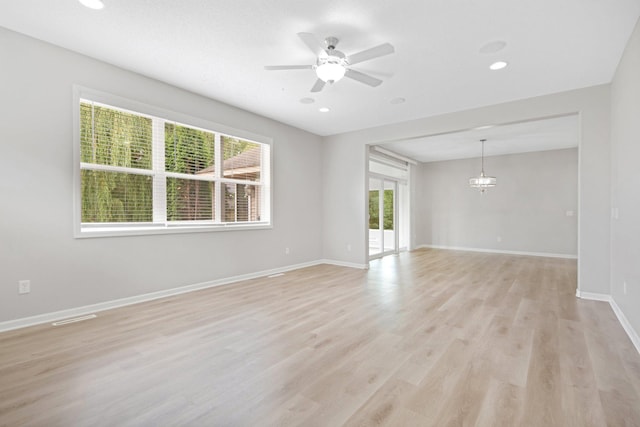 6758 Troy Ln N, Maple Grove, MN 55311 - unfurnished room featuring a ceiling fan, light wood-style floors, a chandelier, and recessed lighting