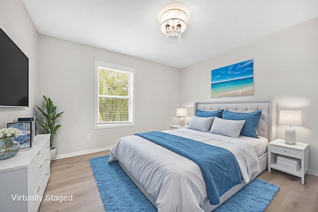 6758 Troy Ln N, Maple Grove, MN 55311 - bedroom with light wood-style flooring and a chandelier