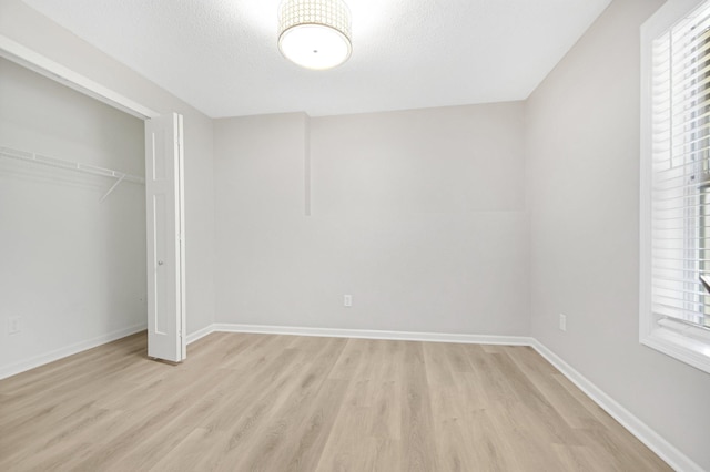 6758 Troy Ln N, Maple Grove, MN 55311 - unfurnished bedroom featuring light wood finished floors, a closet, and a textured ceiling