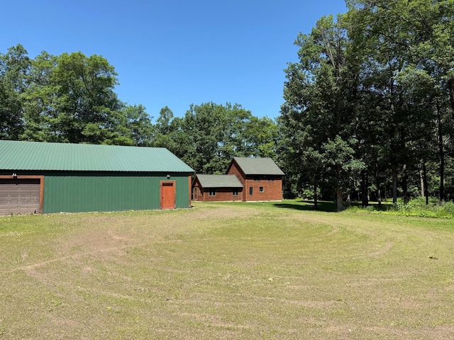43564 Tamarack River Rd, Ogema Twp, MN 55037 - view of green lawn featuring an outbuilding and a garage
