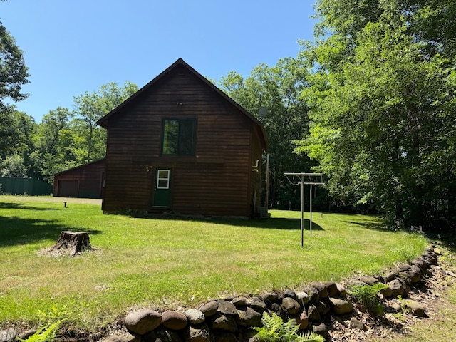 43564 Tamarack River Rd, Ogema Twp, MN 55037 - view of side of property with a yard and a detached garage
