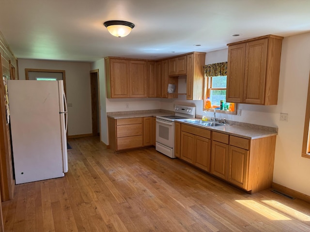 43564 Tamarack River Rd, Ogema Twp, MN 55037 - kitchen featuring white appliances, light wood-type flooring, and light countertops
