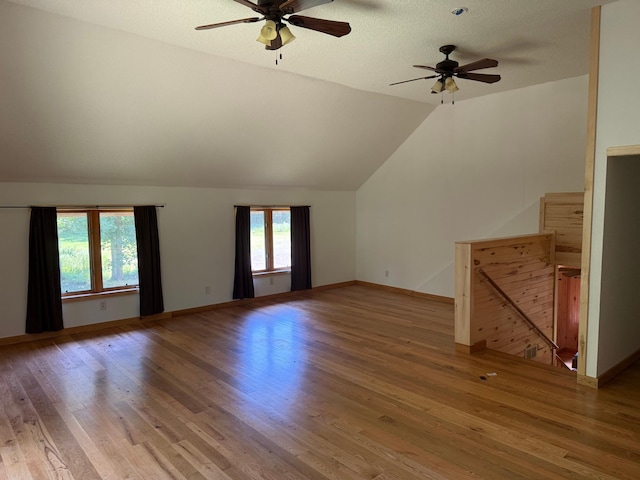 43564 Tamarack River Rd, Ogema Twp, MN 55037 - unfurnished living room featuring a ceiling fan, wood finished floors, and vaulted ceiling