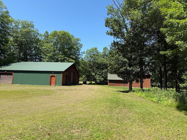 43564 Tamarack River Rd, Ogema Twp, MN 55037 - view of grassy yard with an outbuilding, a garage, and an outdoor structure